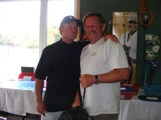 Larry O'Hagan of Saugeen Shores, representing hole sponsor Huntley O'Hagan provides an enthusiastic congratulations to the men's closest to the pin winner Graham Taylor of Walkerton.